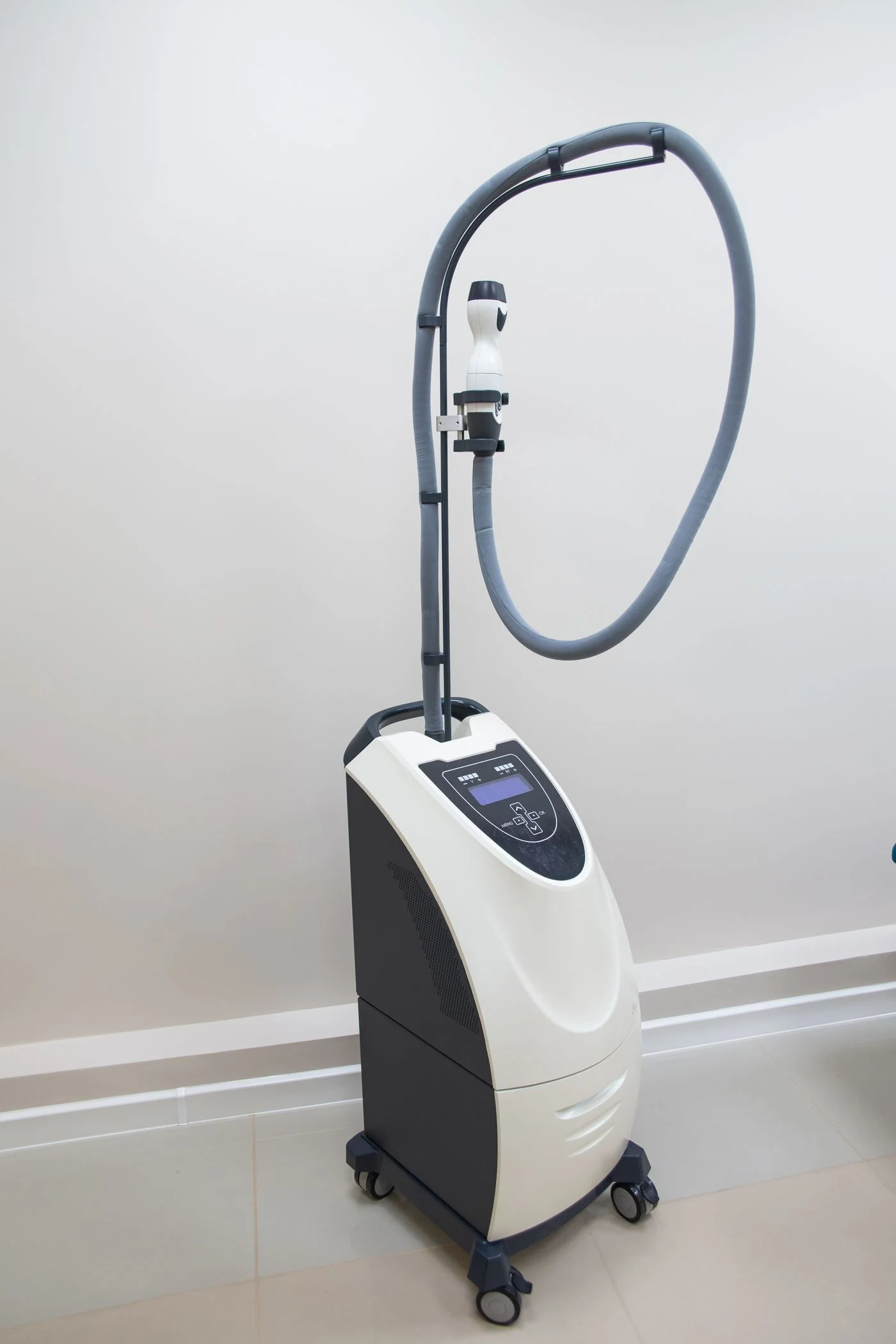 A freestanding medical laser console with delivery hose