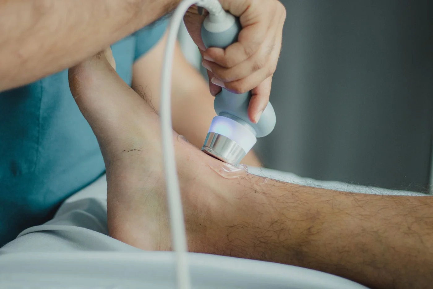 Therapeutic ultrasound handpiece being applied to a leg